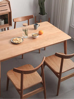 solid wood dining table used as home office desk